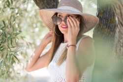Adult woman standing near tree