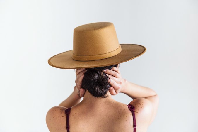 Backside of woman in brown fedora hat