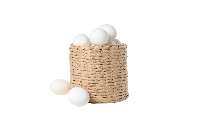 eggs in a round basket, isolated on blank background.