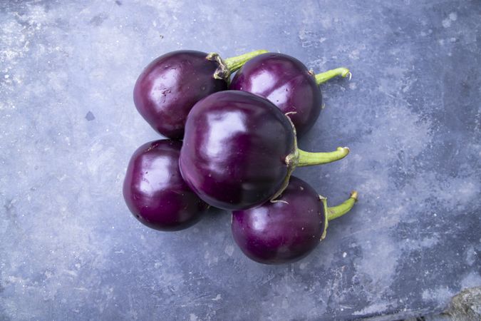 Fresh eggplant on a grey concrete floor