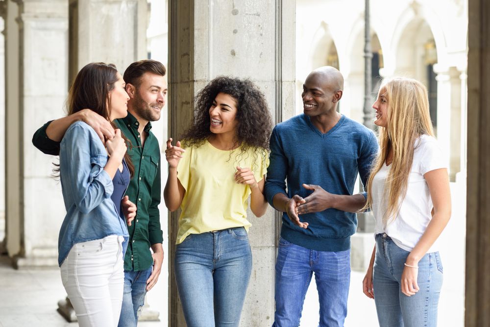 Group of friends standing outside having a chat