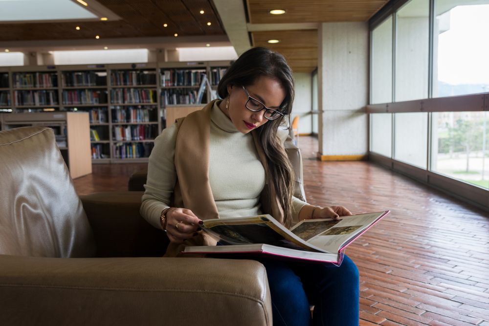 Woman in glasses reading a book