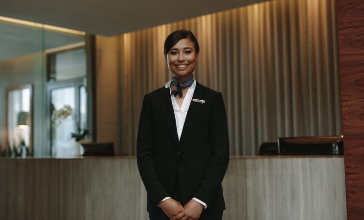 Female hotel workers ready to greet guest