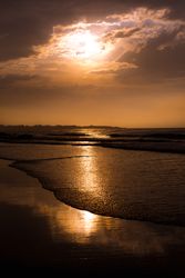 Beautiful evening sky over waving sea and shore