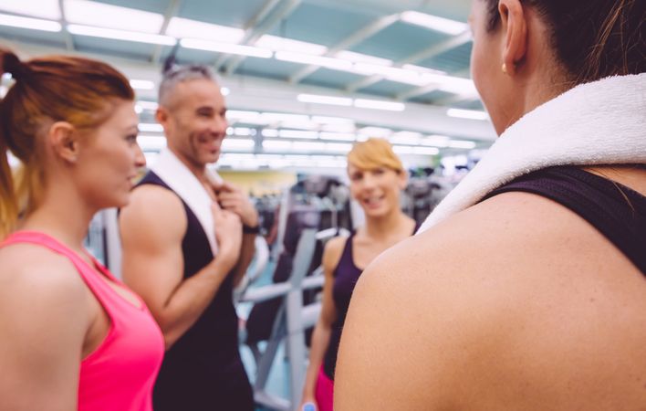 Group of fit people chatting in gym