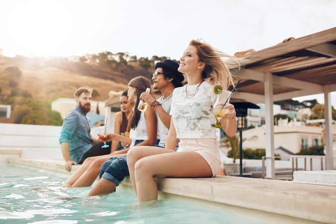Friends relaxing by the pool during a party