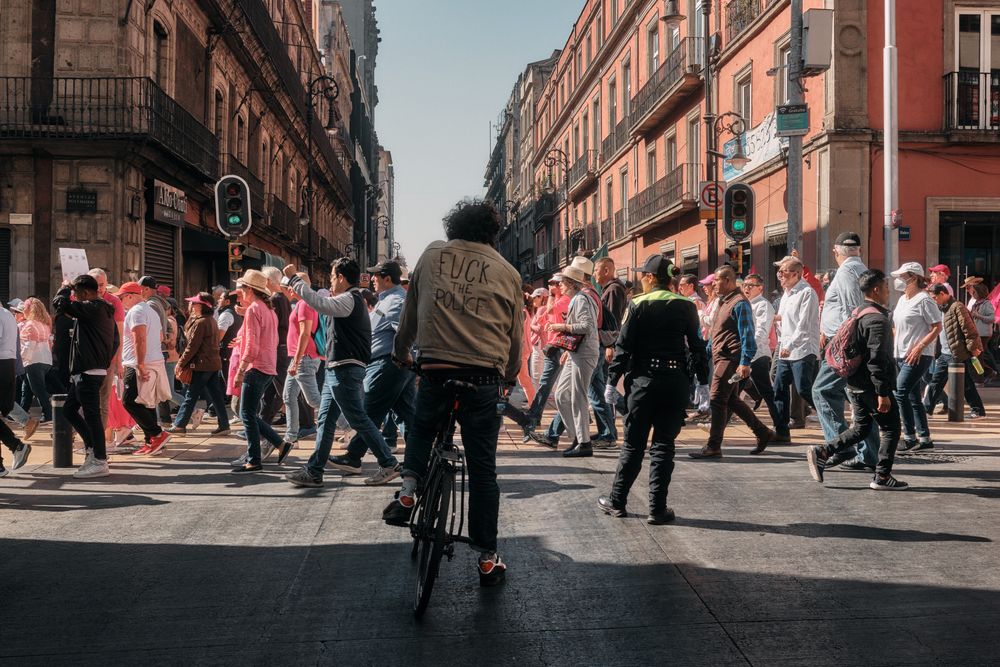 Mexico City, Mexico - February 26th, 2022: Back of man on bike with anti-police slogan on his jacket