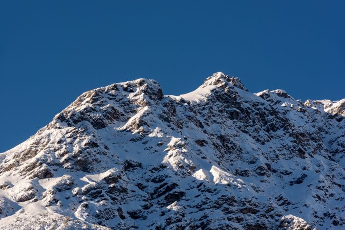 Alpine scenery with a snowy mountain peak against a blue sky, in Bavaria, Germany