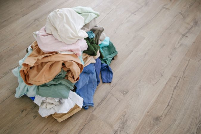 Pile of carelessly scattered clothes on floor.
