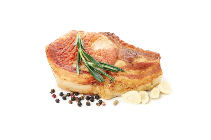 Fried pork steak isolated on light background. Grilled food