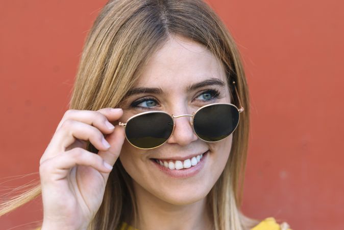 woman in sunglasses smiling at camera