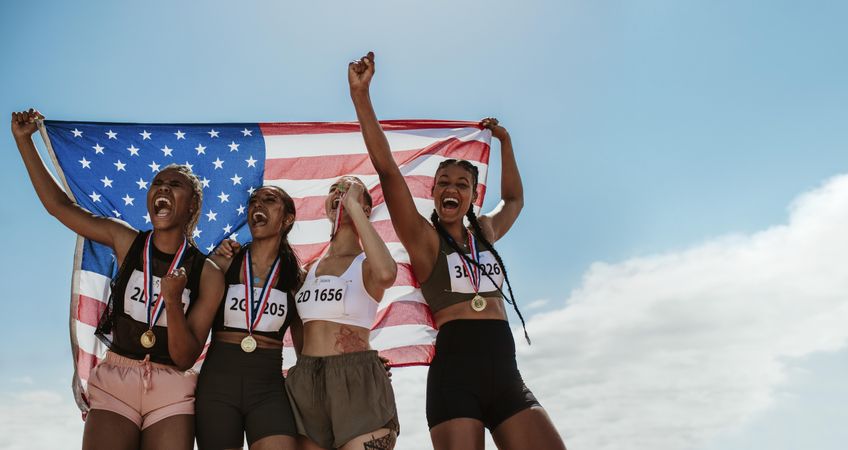 Group of USA runners with medals winning a competition