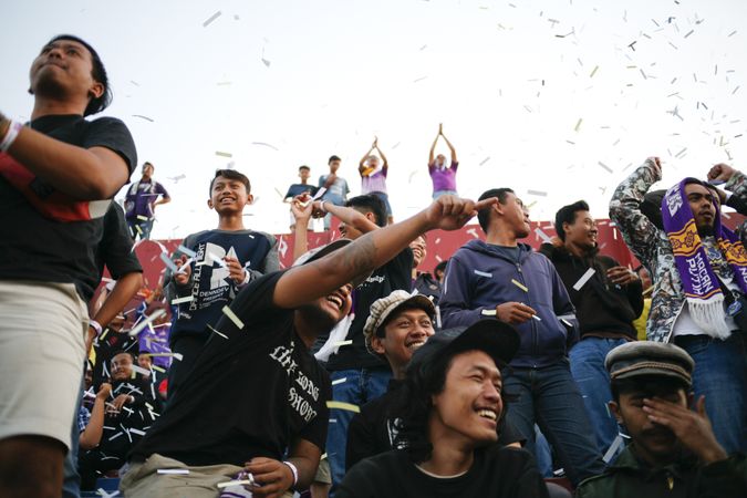 Kedira, East Java Indonesia - October 4, 2019: Soccer fans celebrating a goal with confetti falling
