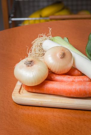 Fresh vegetables on cutting board in the kitchen