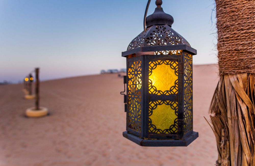 Poles with lanterns in desert