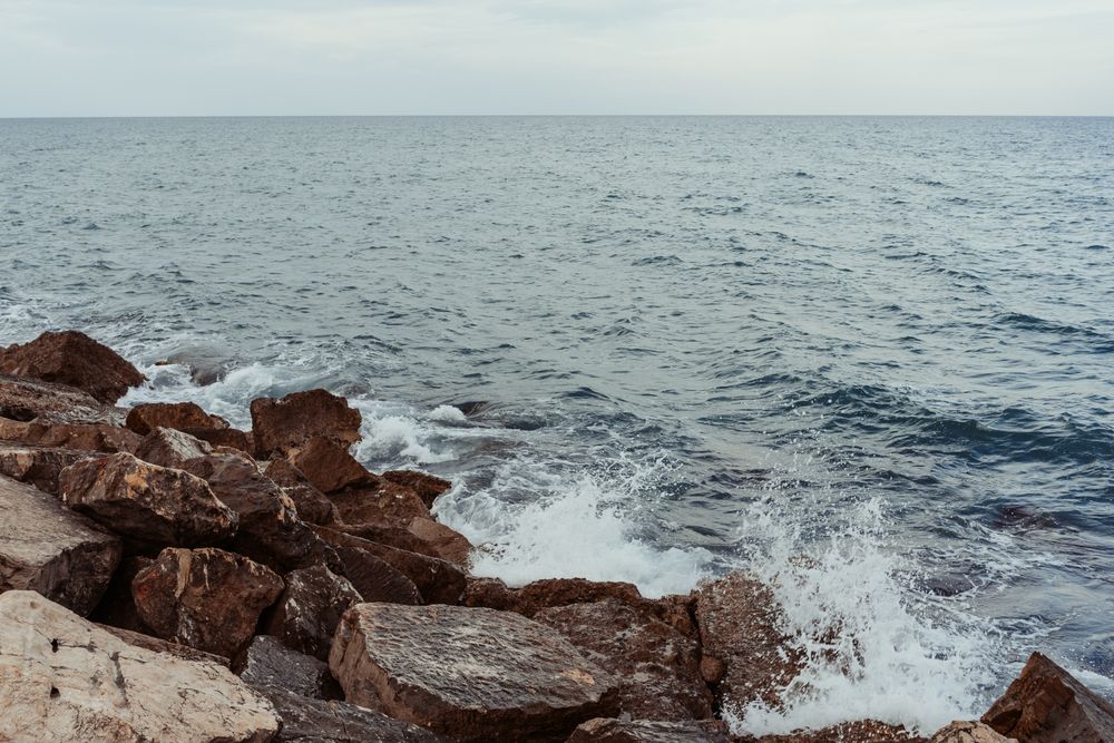 Sea waves hitting rocky cliff