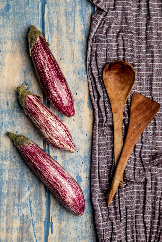 Ripe eggplants on shabby tabletop