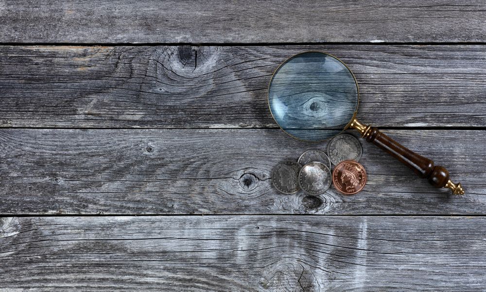 American Morgan silver dollars and cent coin on rustic wood table