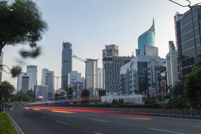 Jakarta, Indonesia - Oct 20, 2019: City skyscrapers in Jakarta and bus and motorcycle traffic