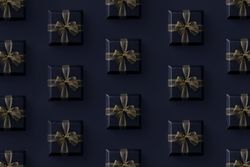 Gift boxes with gold ribbon on dark background