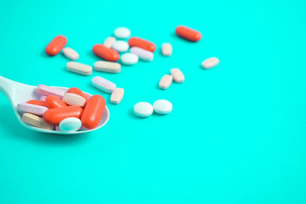 Spoon with colorful pills