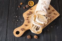 Top view of poundcake on cutting board with spices and dried orange slice