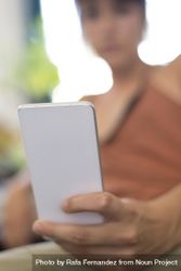 Woman blurred in background checking smartphone bxlErb