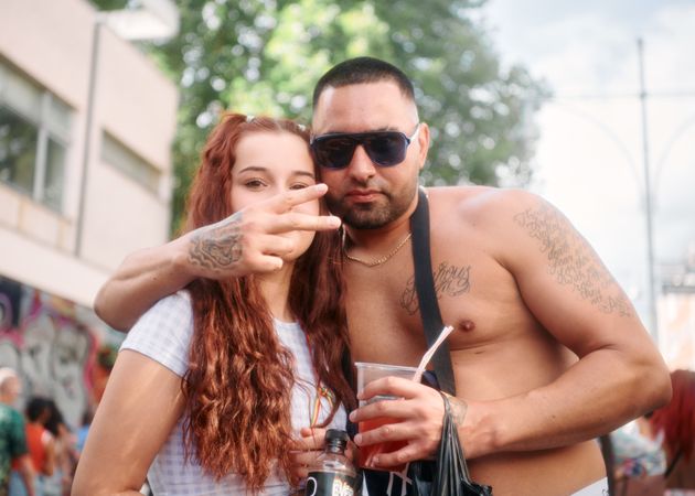 London, England, United Kingdom - August 27, 2022:  Male and female with drinks at street festival