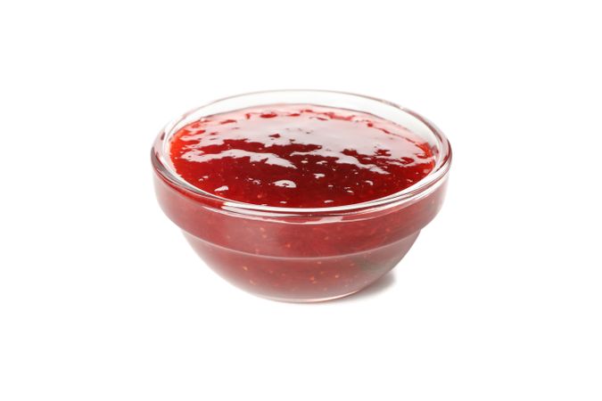 Delicious strawberry jam isolated on plain background