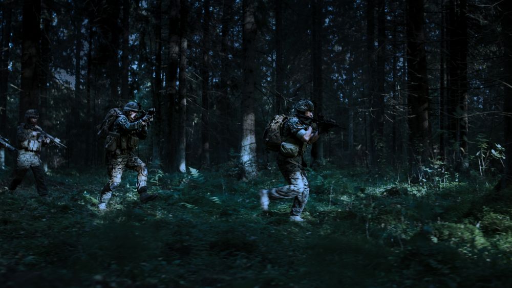 Military Operation in Action, Squad Running in Formation Through Dense Forest at Night.
