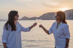 Happy family drinking wine on beach