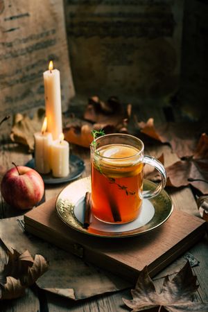 Tea near candles and apple