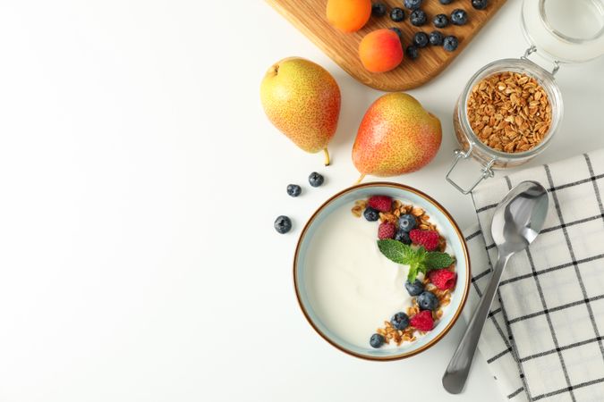 Composition with yogurt dessert and ingredients on neutral background, top view