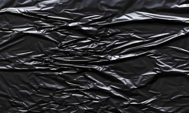 dark crumpled and creased plastic poster texture background