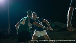 Rugby players fighting for ball in night match 5onj90
