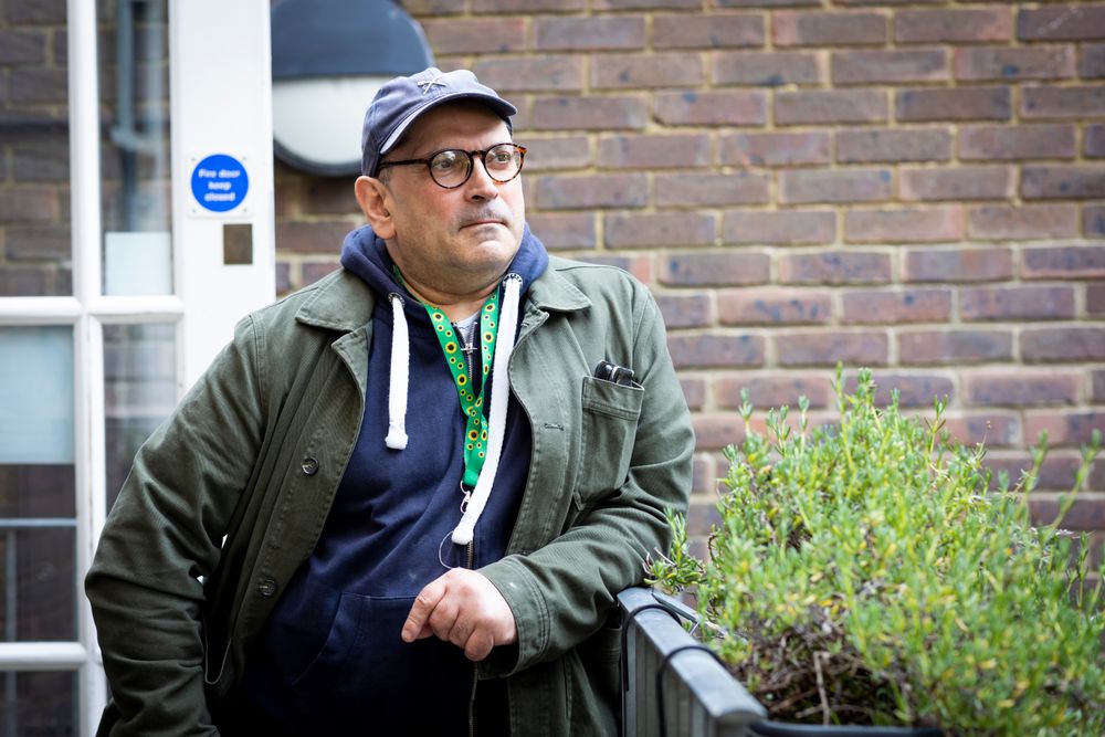Calm man leaning on rail outside