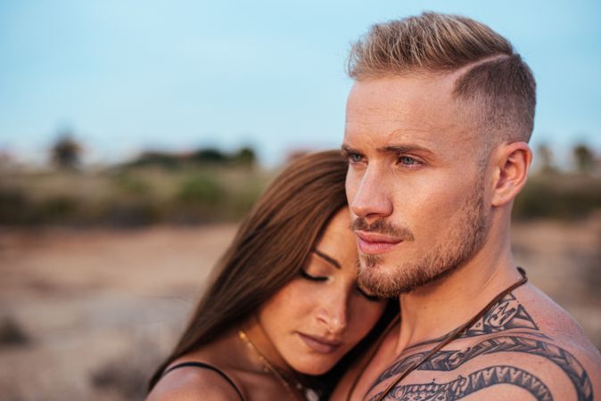 Cool dreamy couple in swimwear on shore