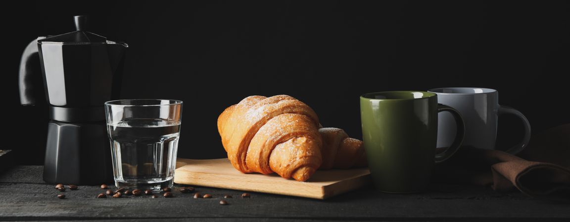 Banner with croissants on wooden breadboard, with space for text