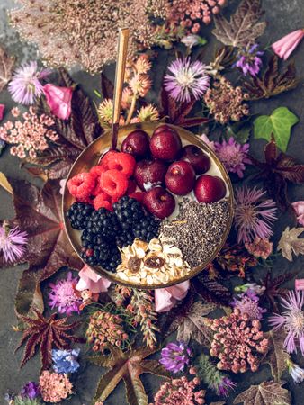 Flowers and tasty breakfast bowl