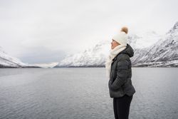 Joyful young woman in warm clothes