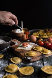 Homemade ravioli made with parmesan cheese, tomato and basil.