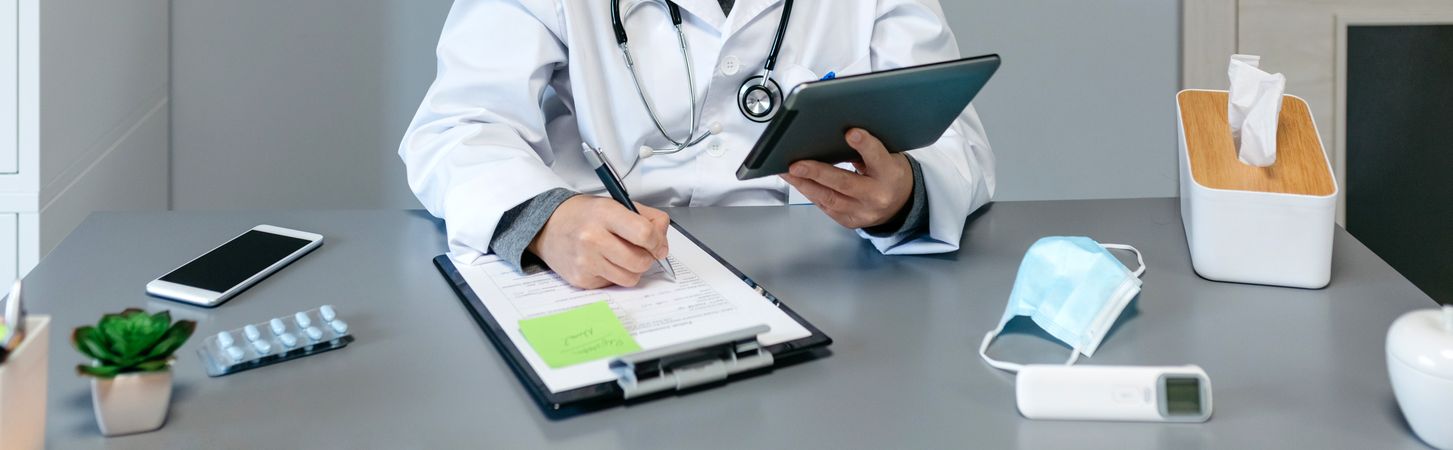 Female doctor doing online consultation with the tablet