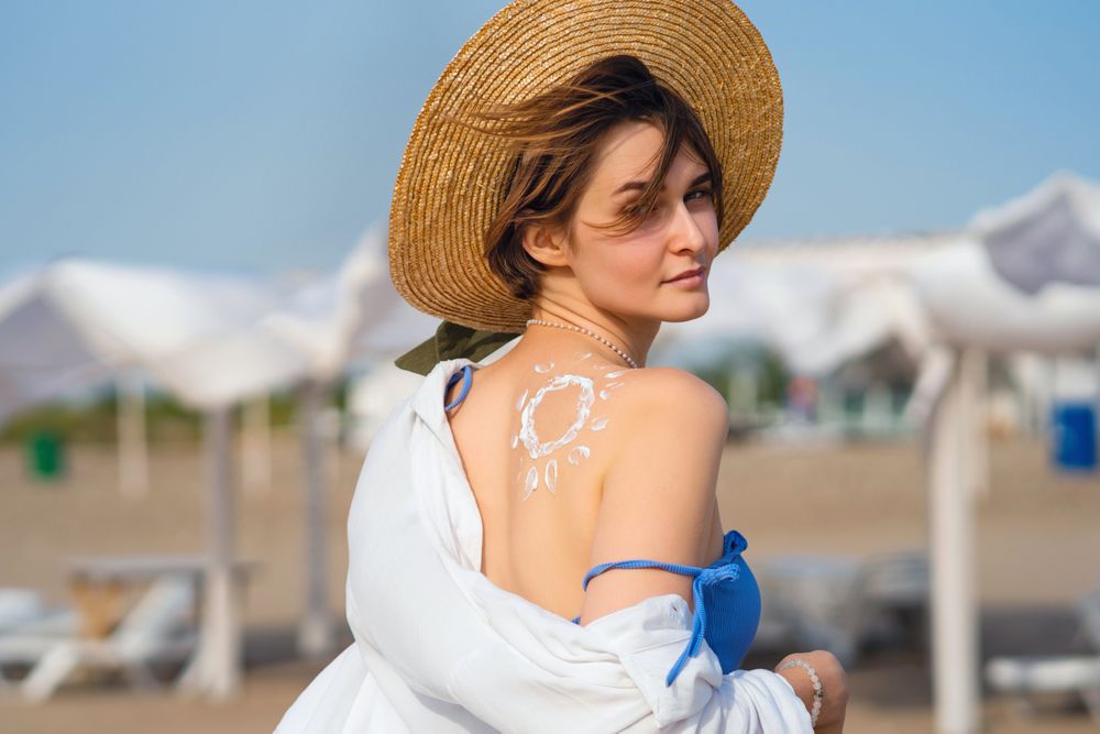 Woman with Sunscreen in sun shape