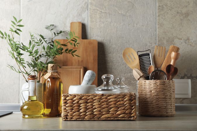 Kitchen table with different supplies and vase with plant