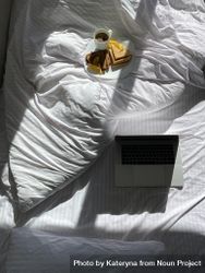 Plate of crepes in bed with coffee and laptop beQ8lb