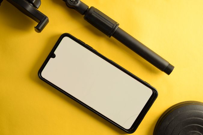 Mock up phone and accessory stand on yellow background
