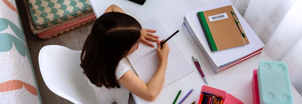 Girl doing homework in her bedroom