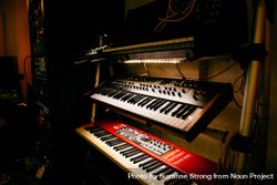 Synth keyboards in a dark studio bYqqz6