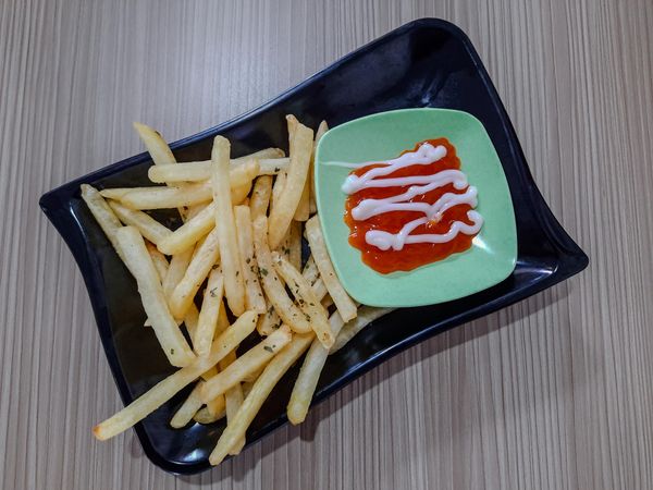 French fries with sauce and mayonnaise with a flat lay concept