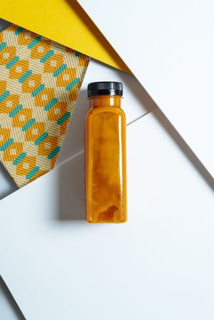 Mango and pumpkin smoothie bottle over retro textures